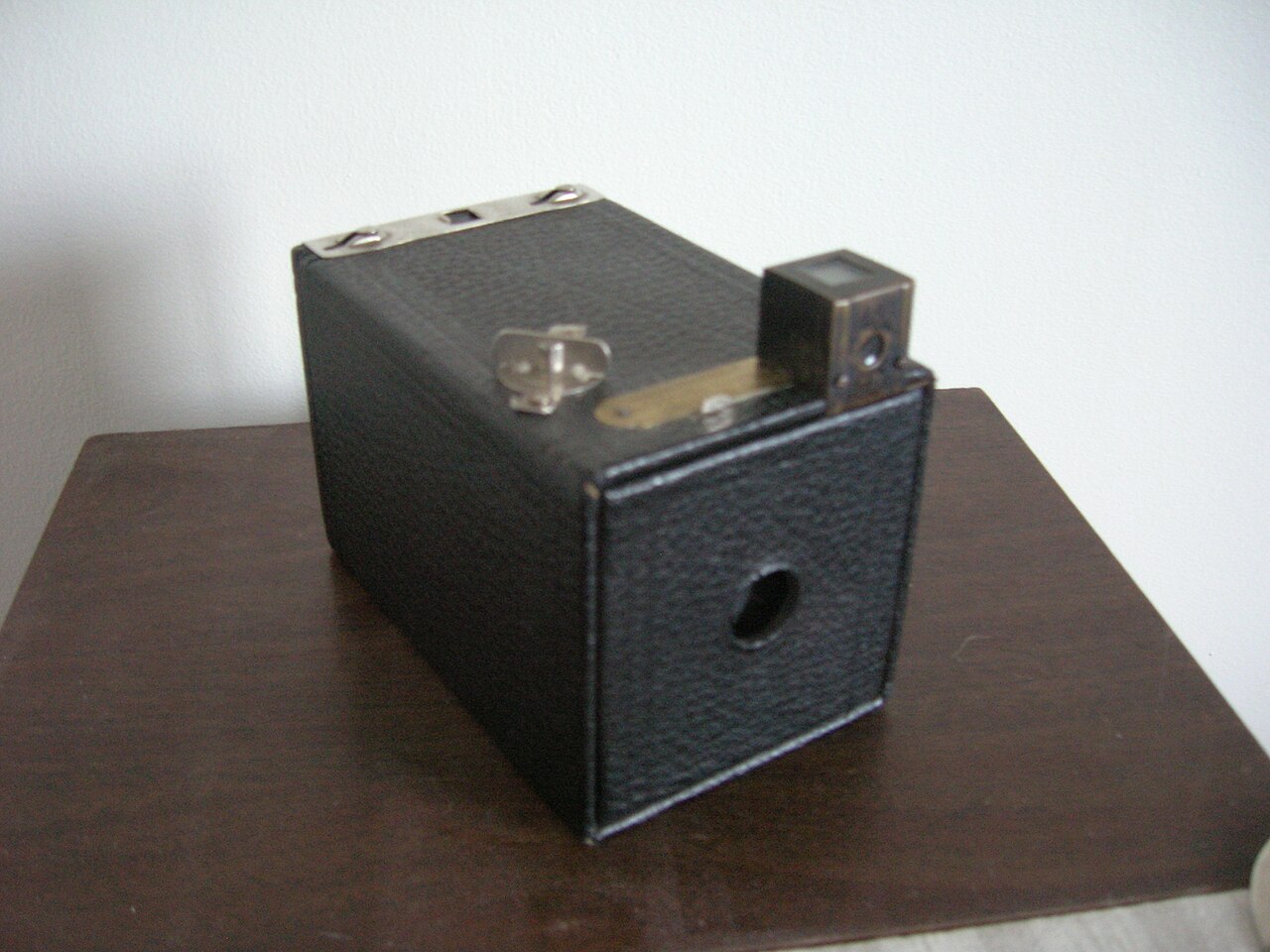 The original Kodak Brownie, a small cardboard box camera with a lens on the front and a clip-on viewfinder